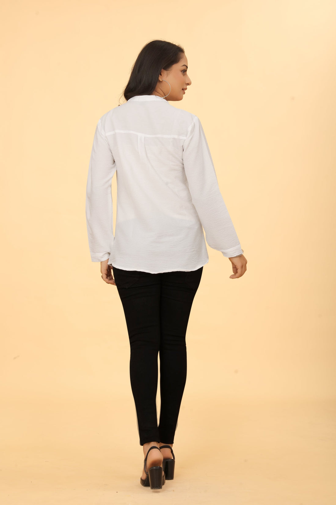 A woman wearing a white casual wear tunic with short sleeves