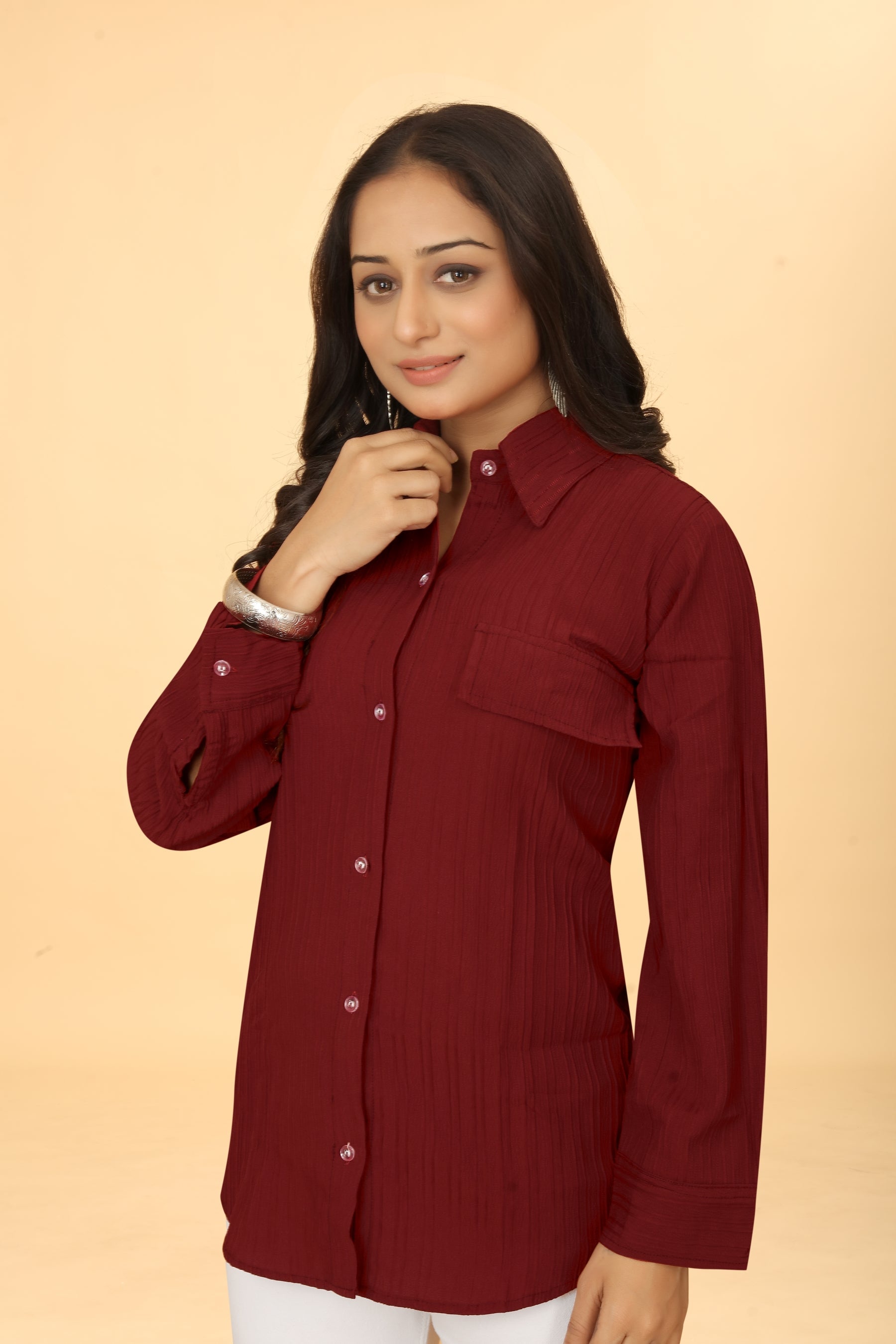 Woman wearing a Maroon button-down collar neck top